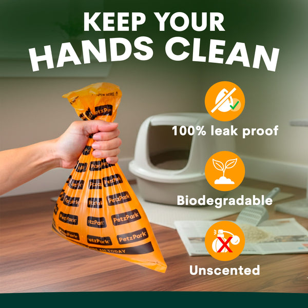 Hand holding an orange cat waste bag with product features highlighted on a table.