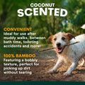 Dog playing with a stick on a dirt path, with text about coconut-scented bamboo products.