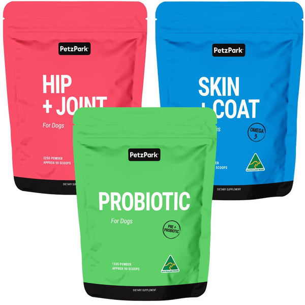 Three bags from the PetzPark Total Health Package for Dogs—pink (Hip + Joint), blue (Skin + Coat), and green (Probiotic)—each clearly labeled with their contents, are designed to provide targeted joint support, gut health, and overall wellness for your canine companion.
